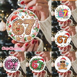 May include: A collection of round Christmas ornaments. Each ornament features the number 67 in various designs, including gingerbread, basketball, and a gingerbread man with sunglasses. Some ornaments have text like "Selena" and "2025".