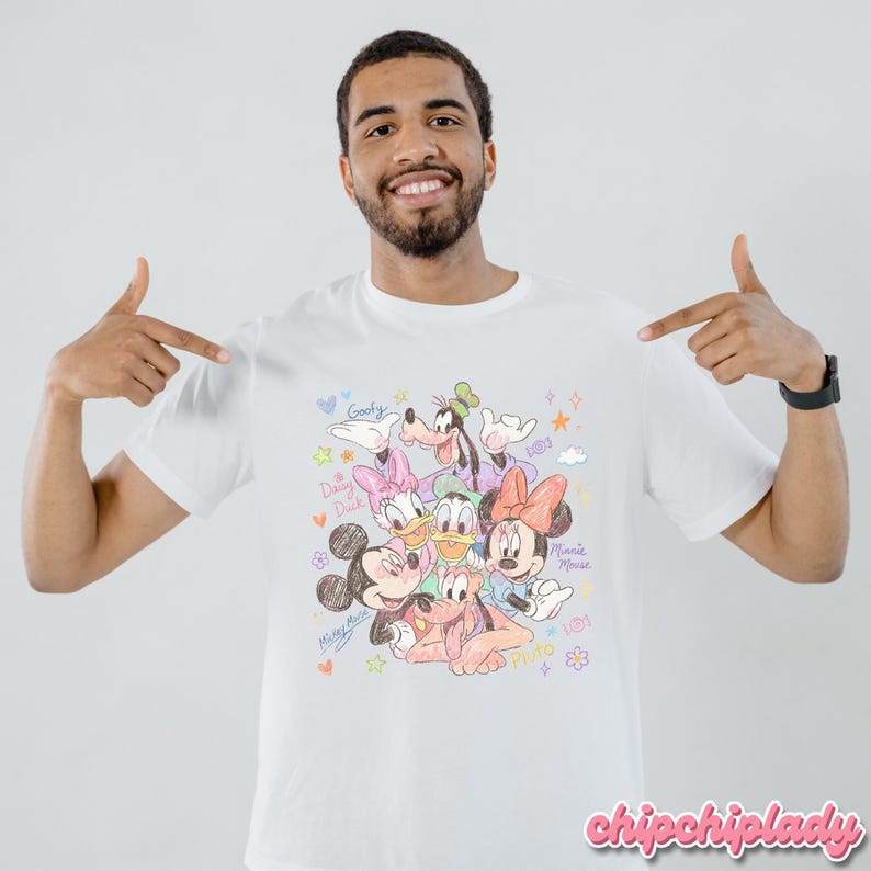 May include: White t-shirt featuring a colorful sketch of Disney characters including Mickey Mouse, Minnie Mouse, Donald Duck, Daisy Duck, Goofy, and Pluto. The shirt has the text "chipchiplady" in pink script at the bottom.
