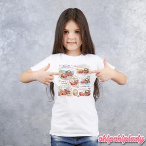 May include: White t-shirt featuring a colorful graphic of the Cars characters, Lightning McQueen and Mater, in various scenes. The design includes text such as "Summer besties" and "Forever my buddy".