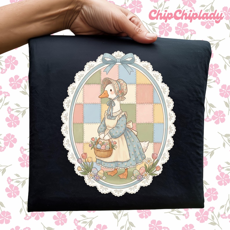 May include: Black pillow with a whimsical illustration of a goose wearing a bonnet and apron, carrying a basket of eggs and flowers. The artwork is framed by a white lace-like border and a blue bow. The text "ChipChipLady" is in the upper right corner.