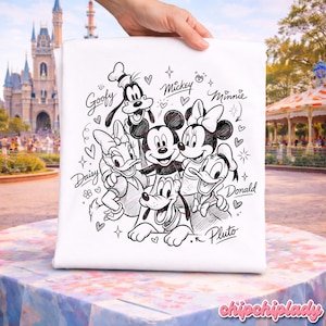 May include: White tote bag featuring a black and white illustration of Disney characters Mickey Mouse, Minnie Mouse, Goofy, Donald Duck, Daisy Duck, and Pluto. The names of the characters are written above them. Hearts and stars surround the characters.
