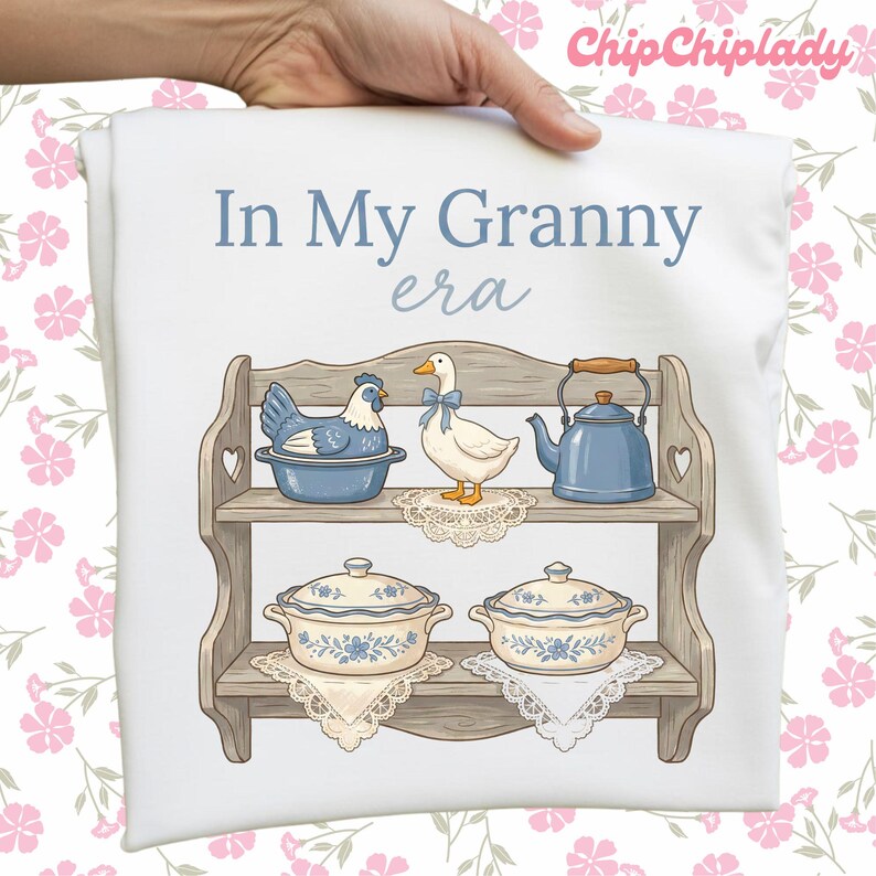 May include: White pillowcase with the text "In My Granny era" and a graphic of a wooden shelf with a blue chicken, a white duck with a blue bow, a blue teapot, and two blue and white casserole dishes.