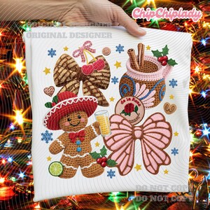 May include: White fabric with a colourful embroidered design featuring a gingerbread man, bows, a mug with cinnamon sticks, and the text "Chip Chiplady" and "Original Designer".