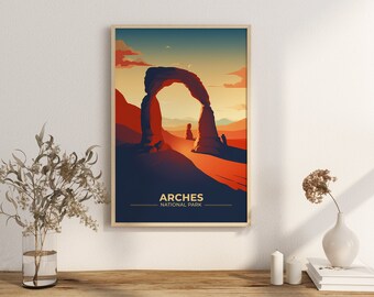 May include: Framed art print featuring a stylized illustration of Delicate Arch in Arches National Park. The artwork uses warm colors, depicting the arch against a sunset sky. Text at the bottom reads "Arches National Park."