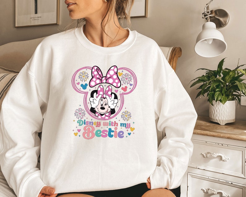 May include: White sweatshirt with a pink Minnie Mouse graphic and the text "Disney with my Bestie" in rainbow colors.