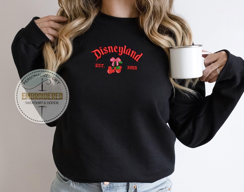 May include: Black sweatshirt with the text "Disneyland Est. 1955" and a red cherry graphic.