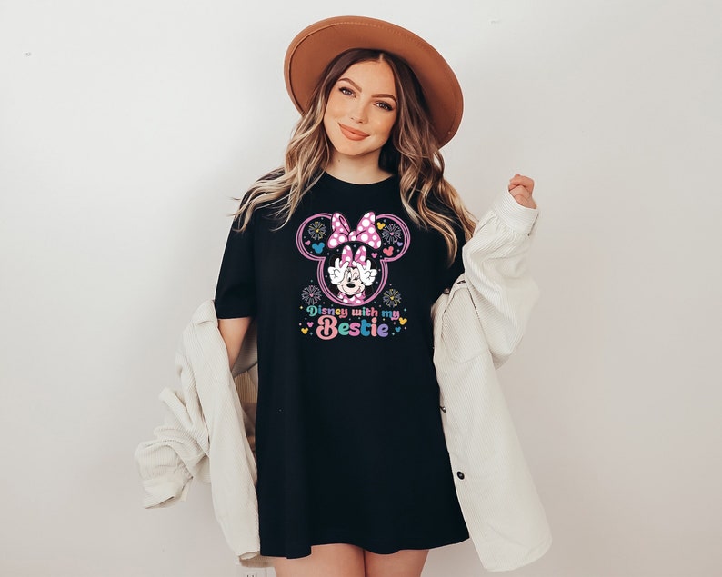 May include: Black t-shirt with a pink Minnie Mouse graphic and the text "Disney with my bestie".