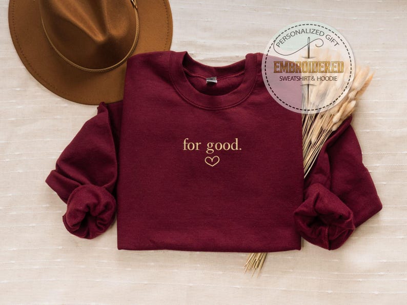 May include: Burgundy sweatshirt with the text "for good." embroidered in gold on the front.