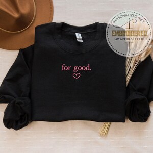 May include: Black sweatshirt with the text "for good." embroidered in pink with a small pink heart.