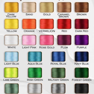May include: A color chart displaying thread color options. The chart includes a variety of colors, such as yellow, orange, red, pink, blue, green, grey, and black. The text "Thread Color Options" is at the top.