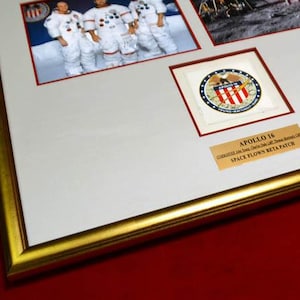 May include: A framed photograph of the Apollo 14 mission crew, with a close-up of the mission patch and the text "Apollo 14,  United States of America, 1971, Space Flown Beta Patch".