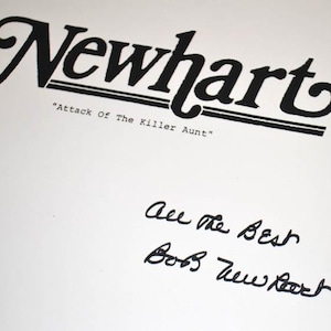 May include: A black and white image of a script for the television show "Newhart" with the title "Attack of the Killer Aunt." The script is signed by Bob Newhart with the message "All the Best".