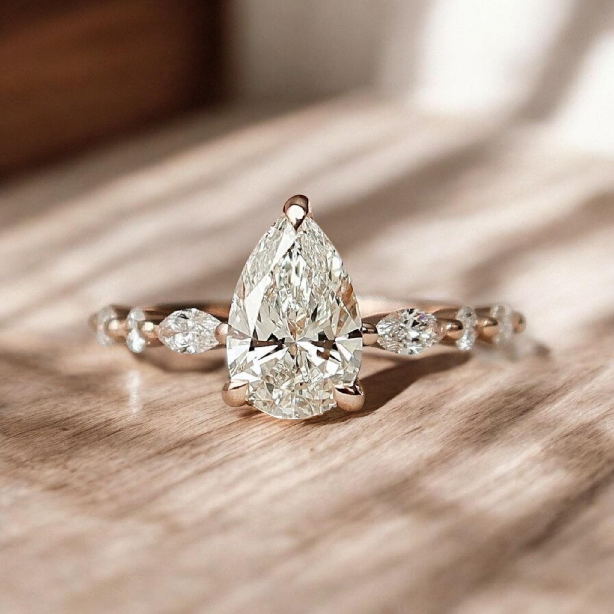 Pear Cut Engagement Ring With Side Stones | Three Stone Moissanite ...