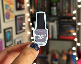 May include: A sticker of a nail polish bottle with the text "Morally Grey" on the label.