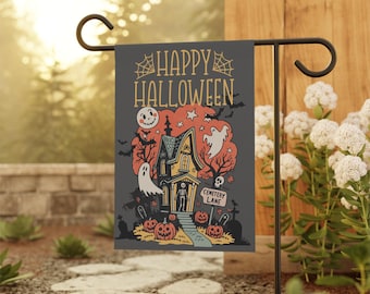 May include: A Halloween garden flag with a spooky haunted house design. The flag features the text "HAPPY HALLOWEEN" above a cartoon illustration of a haunted house, ghosts, bats, and jack-o'-lanterns. The flag is displayed on a black metal garden stake.