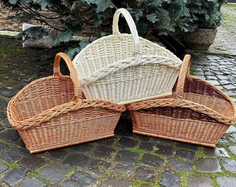 May include: Three woven wicker baskets, one white and two brown, with handles. The baskets are stacked on top of each other.