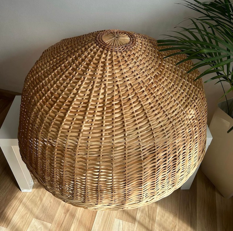 May include: A large, round, natural woven wicker lampshade with a light brown color.