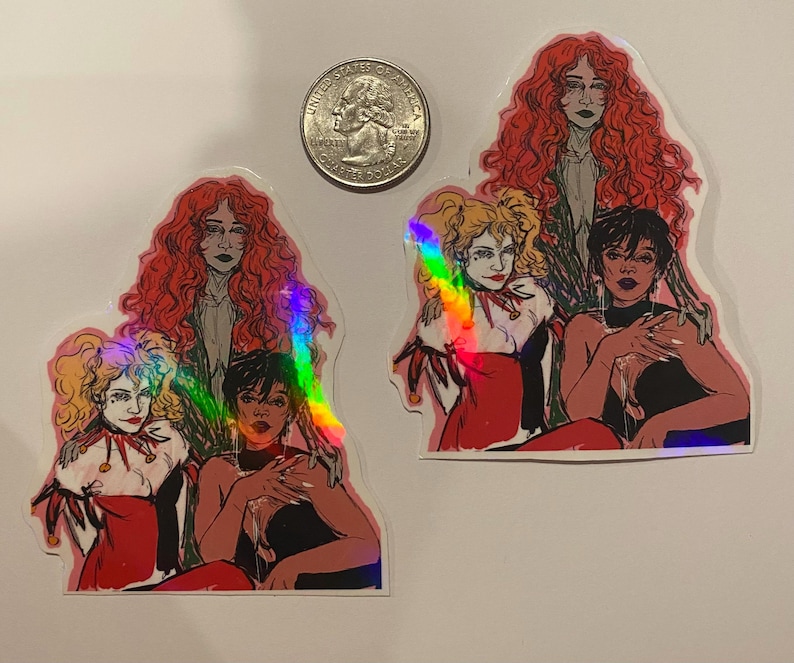 Op de afbeelding: Vier vrouwen met rood, zwart en blond haar worden afgebeeld in een kleurrijke illustratie. De vrouwen dragen verschillende outfits, waaronder een rode jurk, een zwarte jurk en een wit shirt. De illustratie is gedrukt op een sticker met een holografische afwerking.