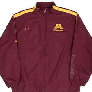 May include: A white ceramic mug with a colorful floral design. The mug features a variety of flowers in shades of pink, purple, and yellow. The handle is a solid white color. The mug is likely used for drinking beverages.