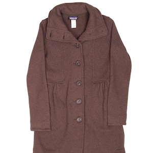 May include: A brown wool coat with a wide collar and button-up front. The coat features a tailored design with a slightly flared bottom and long sleeves. The Patagonia logo is visible on the label. The coat is approximately 40 inches long.