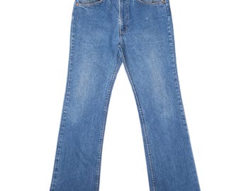 Jeans vintage Levi's 517 bootcut con etichetta arancione, colore indaco, anni '80, taglia 31x32, made in USA.