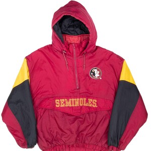 May include: A red, yellow, and black hooded anorak jacket with the word "SEMINOLES" in gold lettering across the front. The jacket features a Seminoles logo patch on the chest and a half-zip closure.