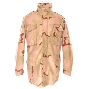 May include: Tan and brown camouflage military jacket with multiple pockets and a high collar. The jacket has a button and zipper closure and is made of a durable fabric. The desert camouflage pattern is visible across the jacket.