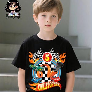 May include: Black t-shirt with a vibrant race car design, including the number 5, chequered flags, and the name "Christopher" in a flame-style font. The design features blue, green, and red race cars.
