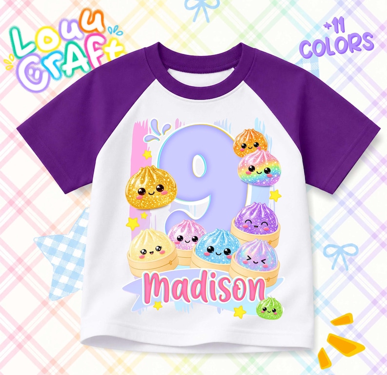 May include: A white t-shirt with purple raglan sleeves featuring a large light purple number 9, the name Madison in pink, and several colorful, smiling dumpling illustrations. The design includes small yellow stars and blue accents.