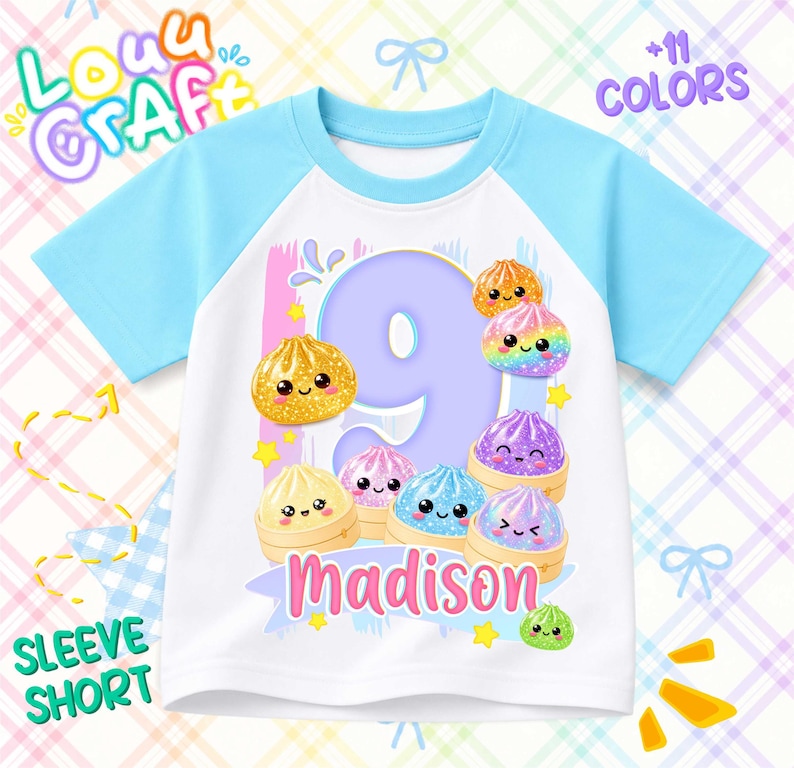 May include: A white short-sleeve raglan t-shirt with light blue sleeves. The front features a large purple number nine surrounded by colorful, smiling cartoon dumplings in bamboo steamers, with the name Madison printed in pink below.