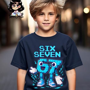 May include: A navy blue t-shirt featuring the text "SIX SEVEN" in a pixelated light blue font. The numbers 6 and 7 are illustrated as cartoon figures with arms, legs, and smiling faces. The t-shirt is worn by a young person.