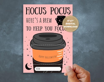 May include: A pink Halloween card with the text "Hocus Pocus, Here's a Brew to Help You Focus." It features a coffee cup graphic with "Happy Halloween!" and a space to write "From:" The card is a 12.7cm x 17.8cm digital download.