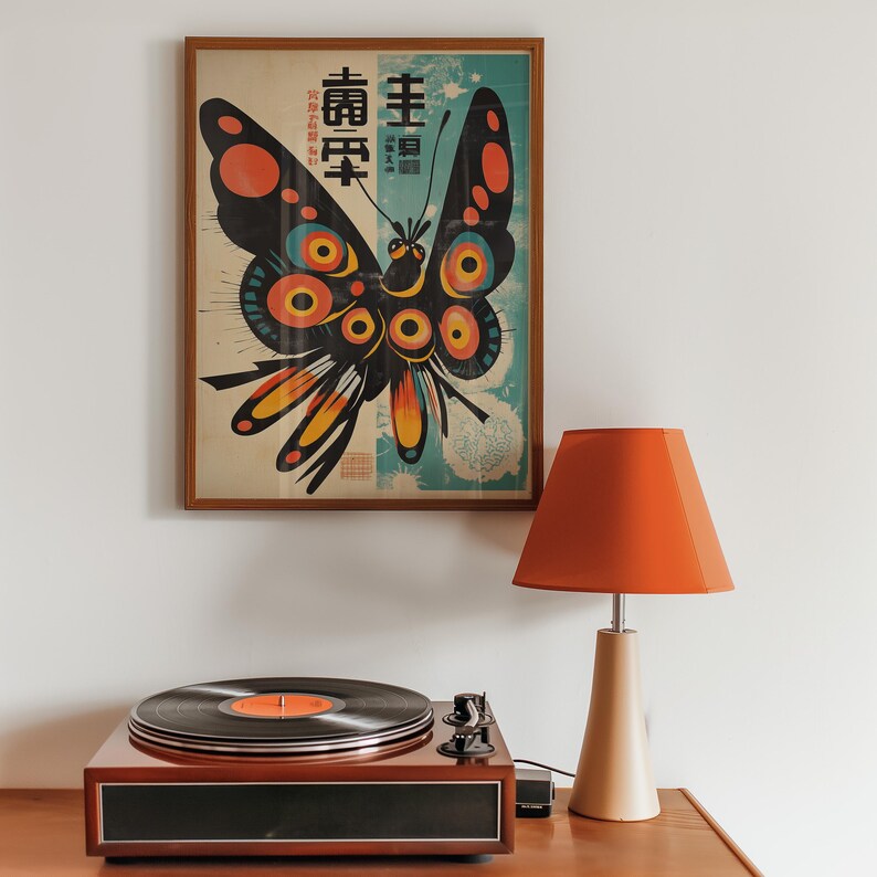 May include: A framed print of a colorful butterfly with black wings and yellow, orange, and red accents. The butterfly is surrounded by a blue and white background with Japanese text that reads "主 壽 昇" and "壽 昇 昇".