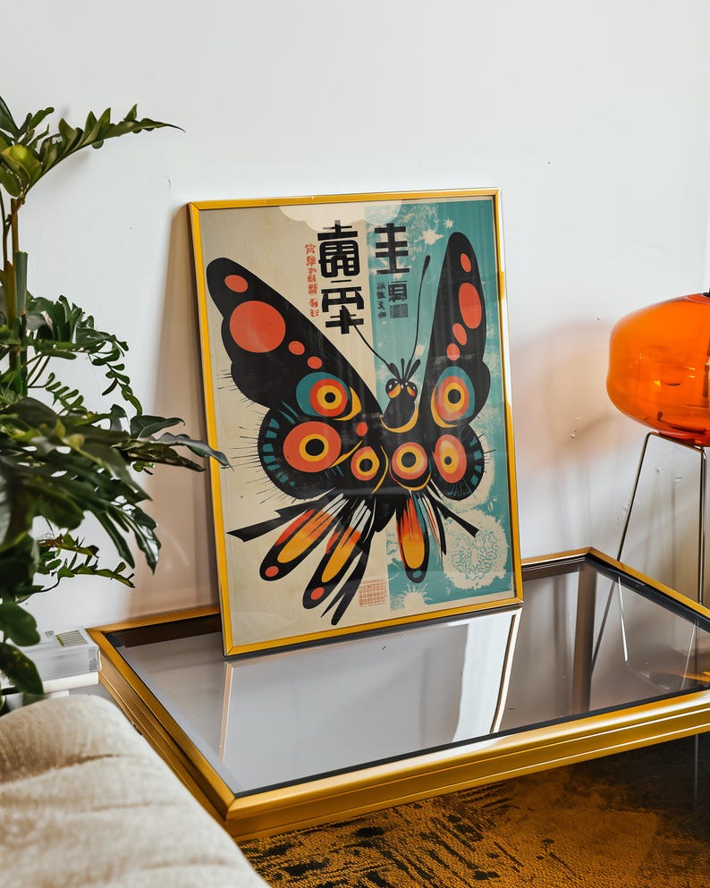 May include: A framed print of a colorful butterfly with black wings and red, yellow, and blue accents. The butterfly is surrounded by a blue and white background with Japanese text that reads "主頁" and "壽百年".
