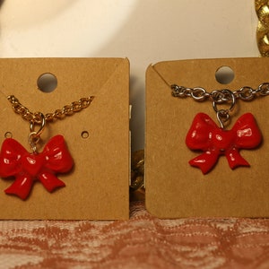 Red bow necklace on gold chain