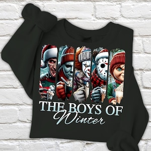 May include: Black sweatshirt featuring a graphic of horror movie characters in winter attire. The design includes Freddy Krueger, Michael Myers, Pennywise, Jason Voorhees, and Chucky, with the text "THE BOYS OF Winter" in white script.