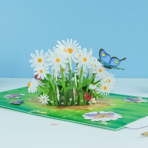 Biglietto pop-up con margherite e farfalle