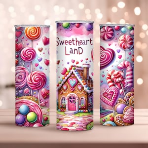 May include: Three stainless steel tumblers with a whimsical candy-themed design. Each tumbler features a different illustration of lollipops, hearts, and a gingerbread house with the text "Sweetheart Land". The color palette includes pink, purple, and red.