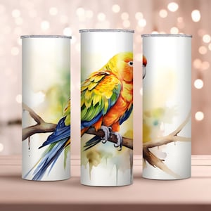 May include: Three white stainless steel tumblers with a watercolor design of a yellow, orange, and green parrot perched on a branch. The background is a soft watercolor wash of blue, green, and yellow.