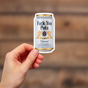 May include: A white ceramic mug with a black handle and the text "But First, Coffee" in a black, handwritten-style font. The mug is on a white surface.