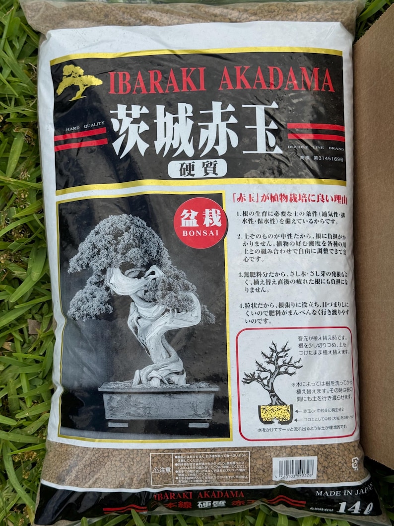May include: A bag of Ibaraki Akadama bonsai soil. The bag is white with red and black text, including "Ibaraki Akadama" and Japanese characters. A bonsai tree illustration is on the bag, along with text in Japanese.