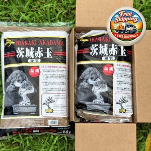 May include: Two bags of Ibaraki Akadama bonsai soil, one inside a cardboard box. The bags are black and white with Japanese text and a bonsai tree illustration. The box has a "Free Shipping" sticker.