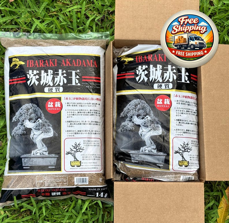 May include: Two bags of Ibaraki Akadama bonsai soil, one inside a cardboard box. The bags are black and white with Japanese text and a bonsai tree illustration. The box has a "Free Shipping" sticker.