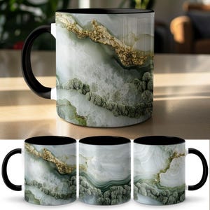 May include: A ceramic coffee mug with a black handle and interior. The exterior features a marbled design in shades of white, green, and gold. The mug has a glossy finish and is suitable for hot or cold beverages.
