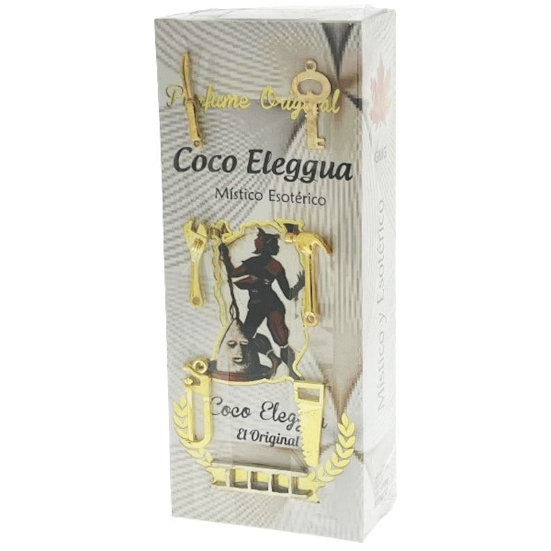 May include: A white box with gold accents featuring a black and white illustration of a person holding a hammer and wrench. The box has the text "Coco Eleggua M&iacute;stico Esot&eacute;rico" and "Coco Eleggua El Original" on it.