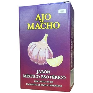 May include: A purple and red box of "Ajo Macho" soap, featuring a garlic bulb illustration. The box also displays the text "JABÓN MÍSTICO ESOTÉRICO" and "PESO NETO: 100 GR".