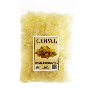 May include: A clear plastic bag filled with pale yellow copal resin. A rectangular label displays the word "COPAL" and "INCENSIO DE RESINA NATURAL". The label also indicates the contents weigh 1 pound.