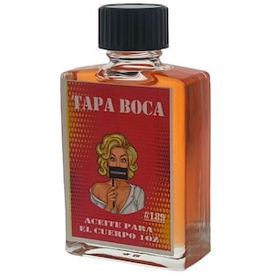 May include: A clear glass bottle with a black cap, labeled "TAPA BOCA #189 ACEITE PARA EL CUERPO 1 OZ". The label features a red background with a white pop art style illustration of a woman with a censored mouth.