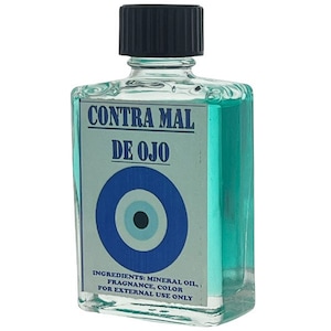 May include: A small, clear glass bottle with a black cap filled with a light blue liquid. The label reads "CONTRA MAL DE OJO" and features a blue evil eye symbol. The ingredients are listed as "Mineral Oil, Fragrance, Color" and "For External Use Only."