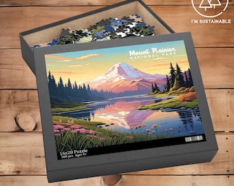 May include: A 500 piece jigsaw puzzle featuring a scenic view of Mount Rainier National Park. The puzzle box is gray and has a picture of the mountain reflected in a lake. The text on the box reads "Mount Rainier National Park" and "16x20 Puzzle 500 pcs. Ages 9+"